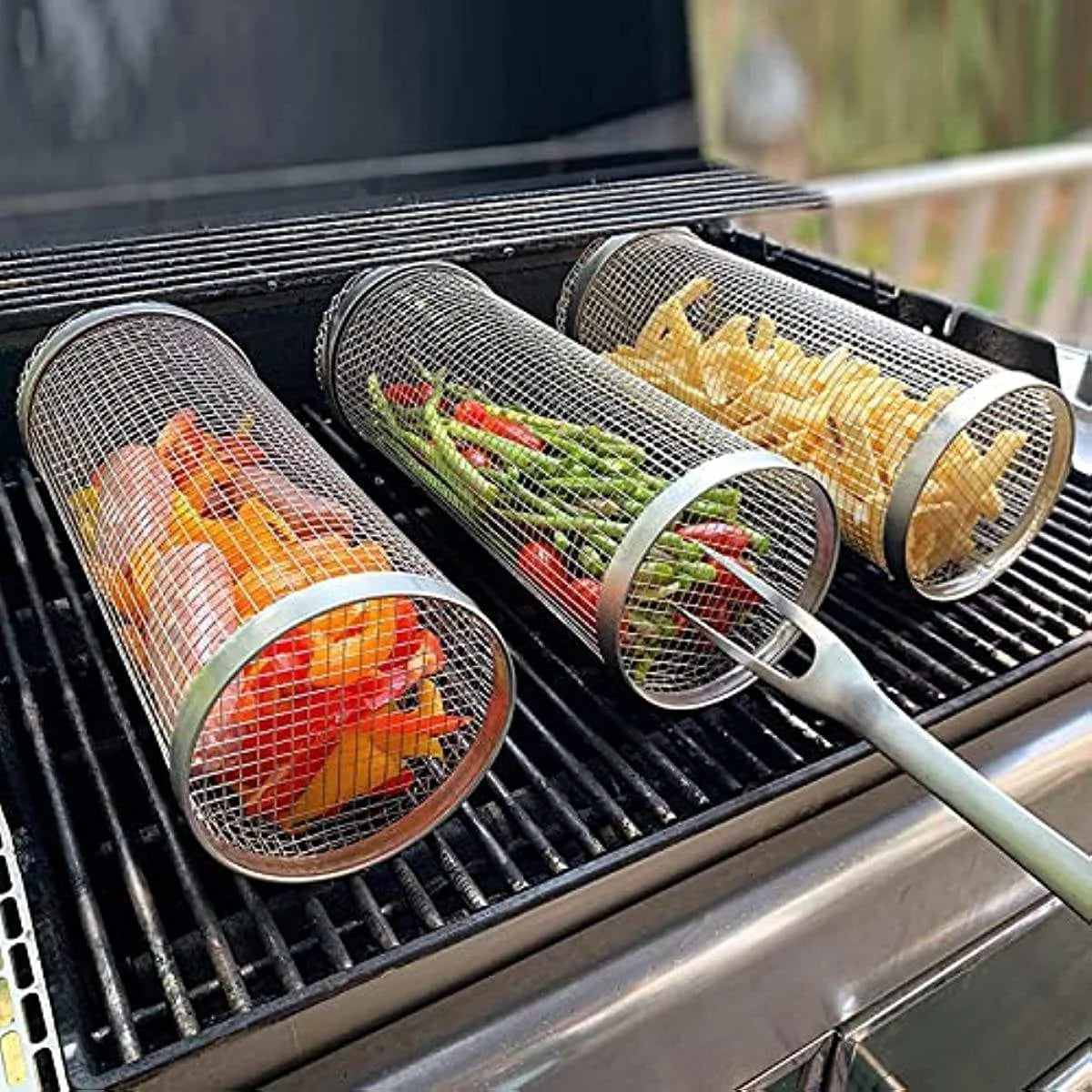 Mesh vegetable grilling baskets with vegetables on a grill